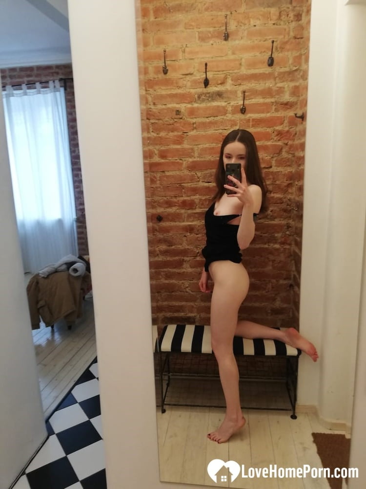 short brunette takes selfies while stripping